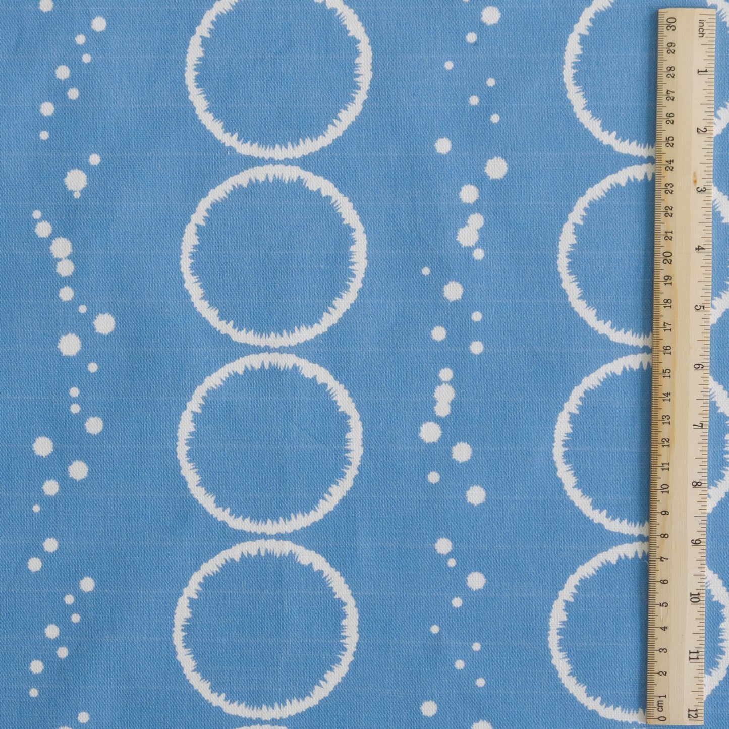 Splash Design in mid blue printed onto white cotton linen for cushions curtains light upholstery and blinds shown in 30cm square