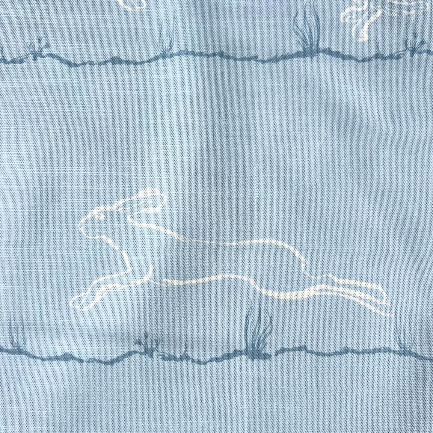Light blue furnishing fabric with white printed  hare design 