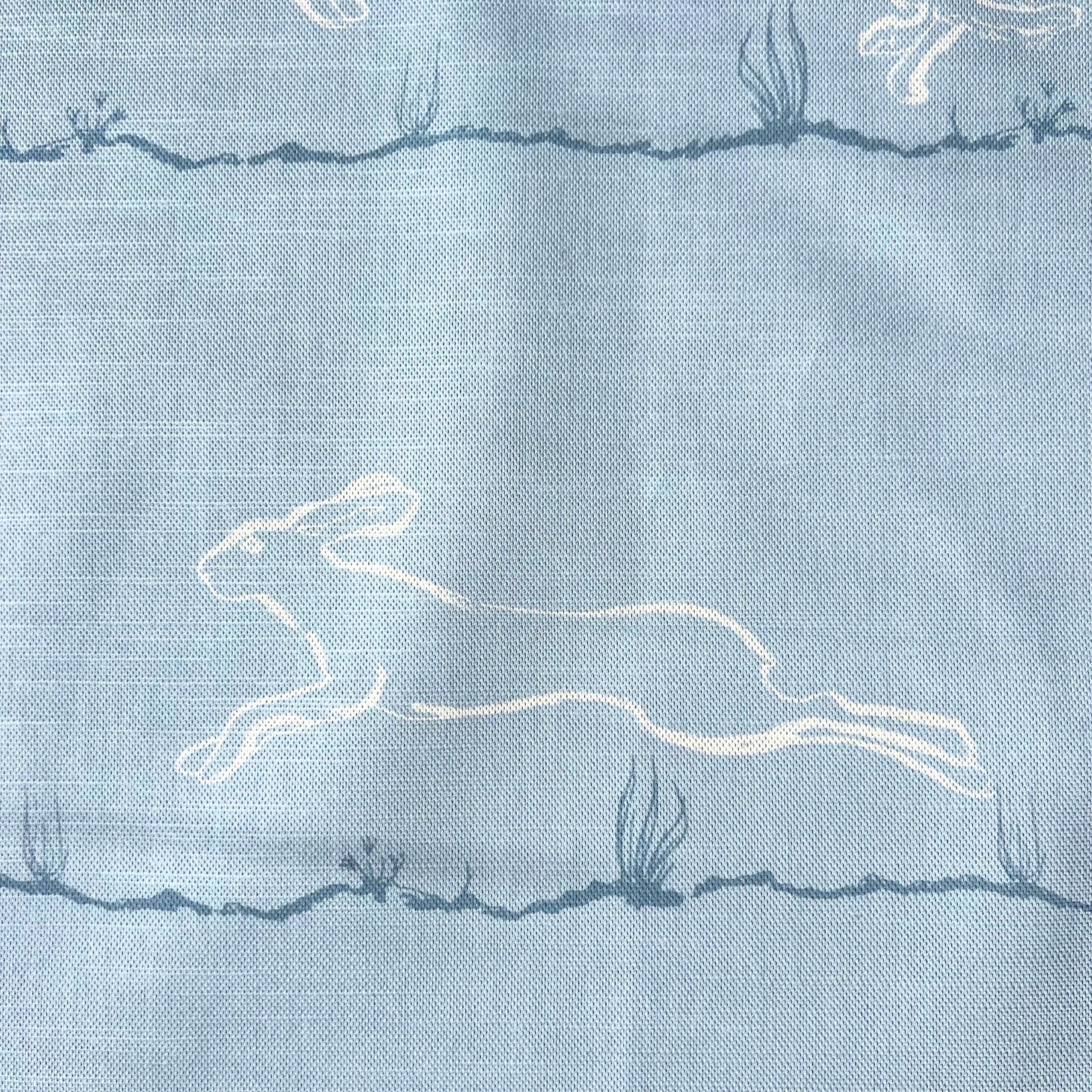 Light blue furnishing fabric with white printed  hare design 