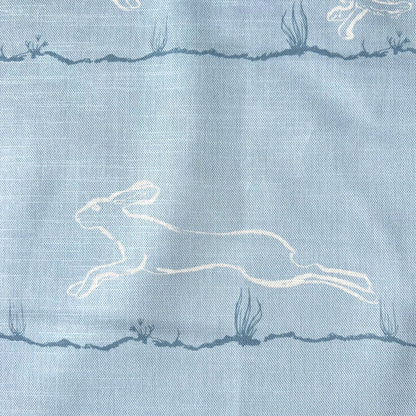 Light blue furnishing fabric with white printed  hare design 