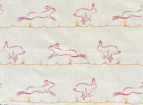 Fabric suitable for interiors projects with red outlines of a hares printed on a natural undyed cloth