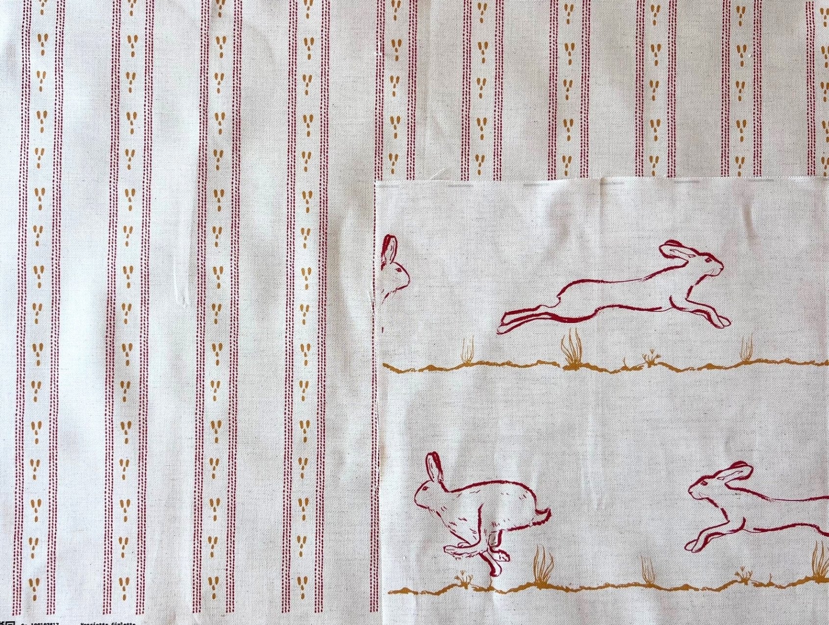 Dashed stripe fabric shown with running hares fabric for interiors. Bespoke colouring options available