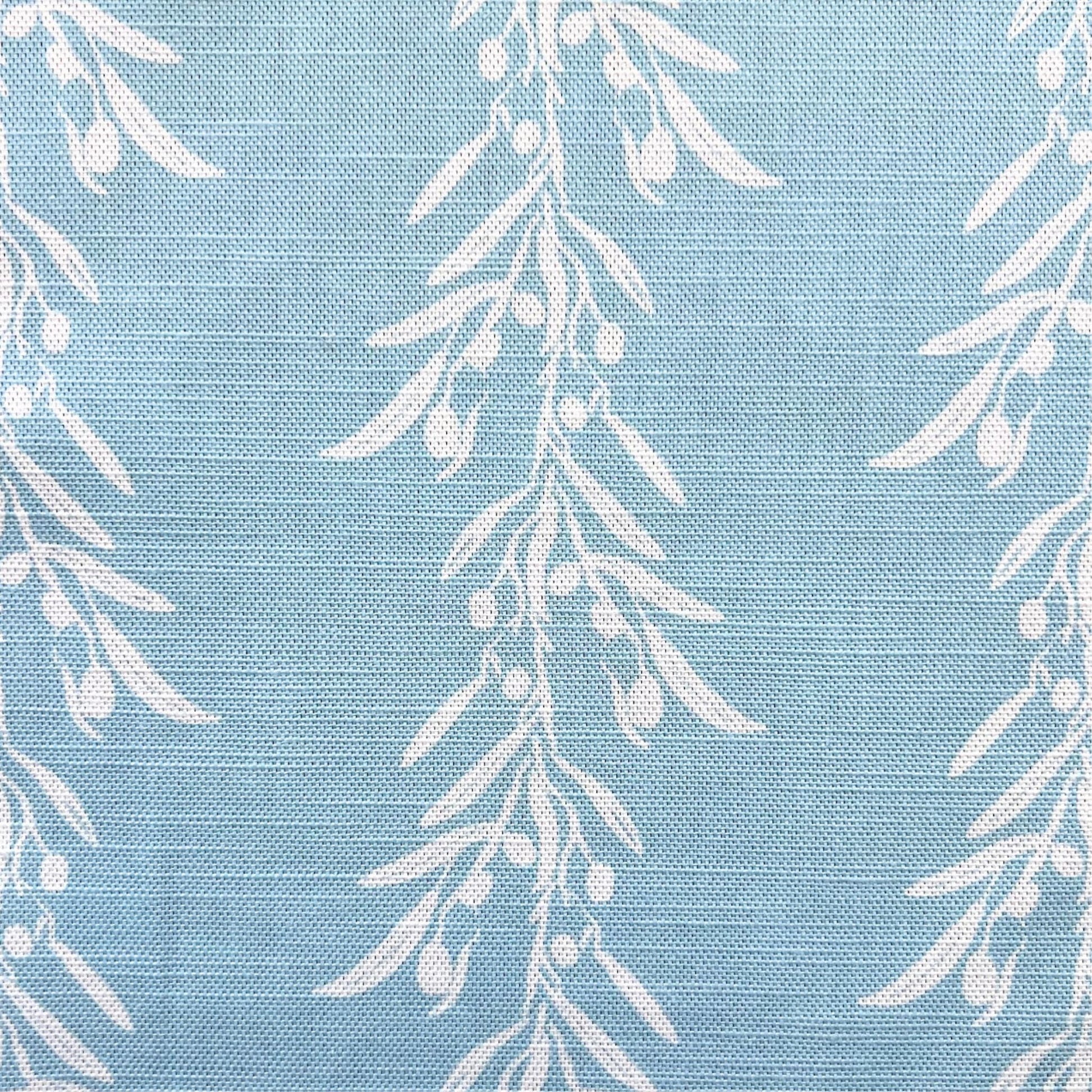 White leaf pattern on a blue fabric background for interior decoration projects