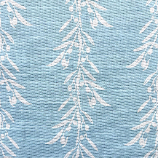 White leaf pattern on a blue fabric background for interior decoration projects