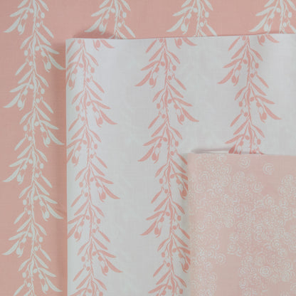 Set of fabric swatches with floral patterns on a pink background